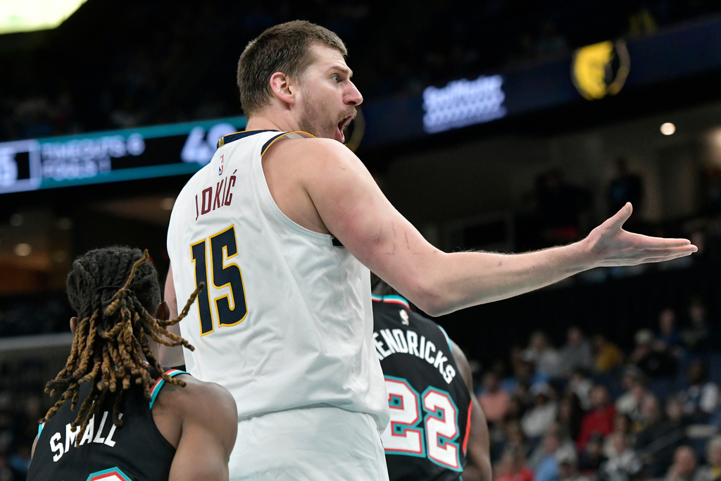 Denver Nuggets center Nikola Jokic (15) reacts in the first half of an NBA basketball game against the Memphis Grizzlies, Wednesday, March 18, 2026, in Memphis, Tenn. (AP Photo/Brandon Dill)