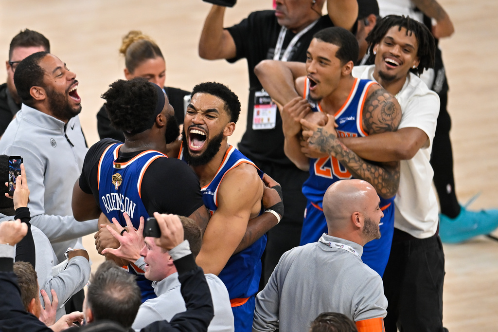 New York Knicks center Karl-Anthony Towns, right, hugs center Mitchell Robinson after defeating the San Antonio Spurs in Game 5 of the NBA Finals basketball series, Saturday, June 13, 2026, in San Antonio. (AP Photo/Darren Abate) CORRECTION: corrects ID to Mitchell Robinson instead Og Anunoby