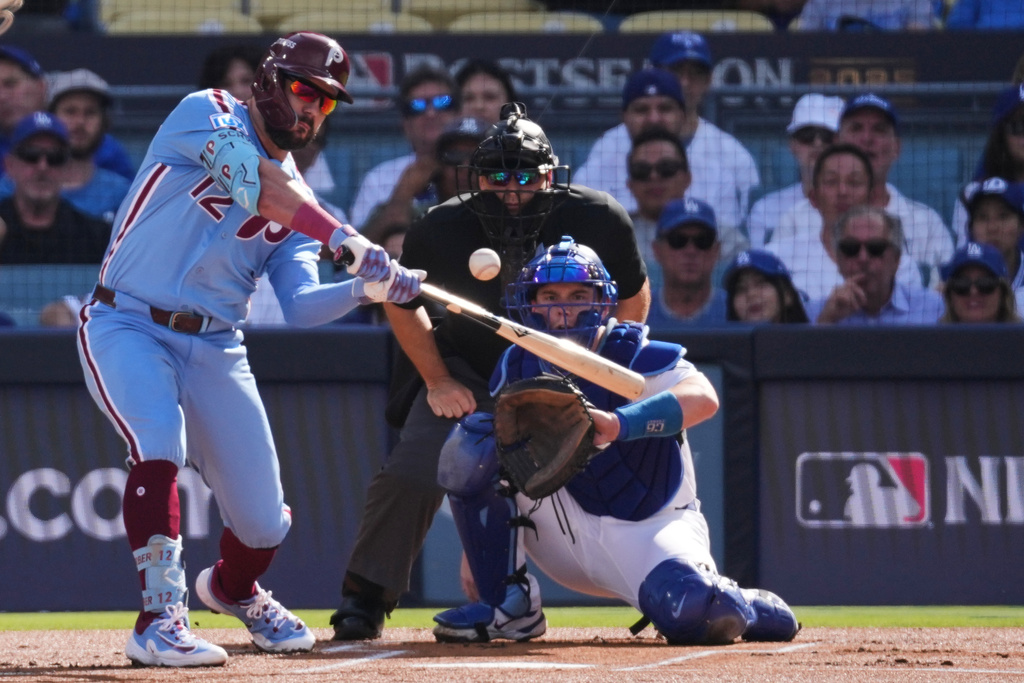 FILE - Philadelphia Phillies' Kyle Schwarber connects for a double during the first inning in Game 4 of baseball's National League Division Series against the Los Angeles Dodgers, Oct. 9, 2025, in Los Angeles. (AP Photo/Jae C. Hong, File)