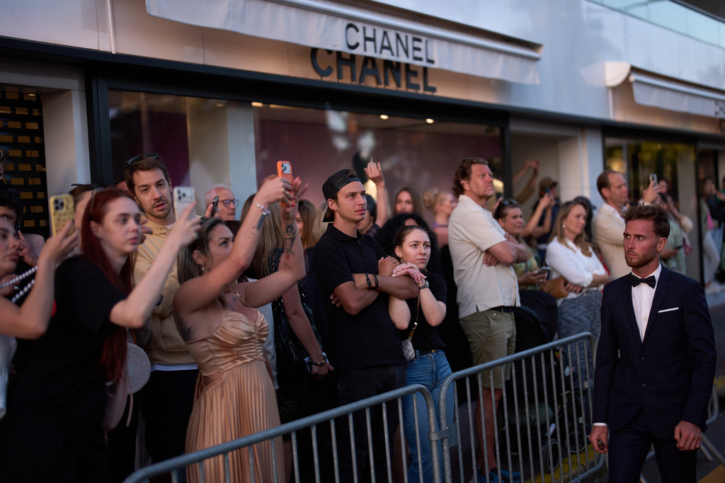 People try to catch a glimpse of celebrities on the red carpet during the 79th international film festival, Cannes, southern France, Wednesday, May 13, 2026. (AP Photo/John Locher)