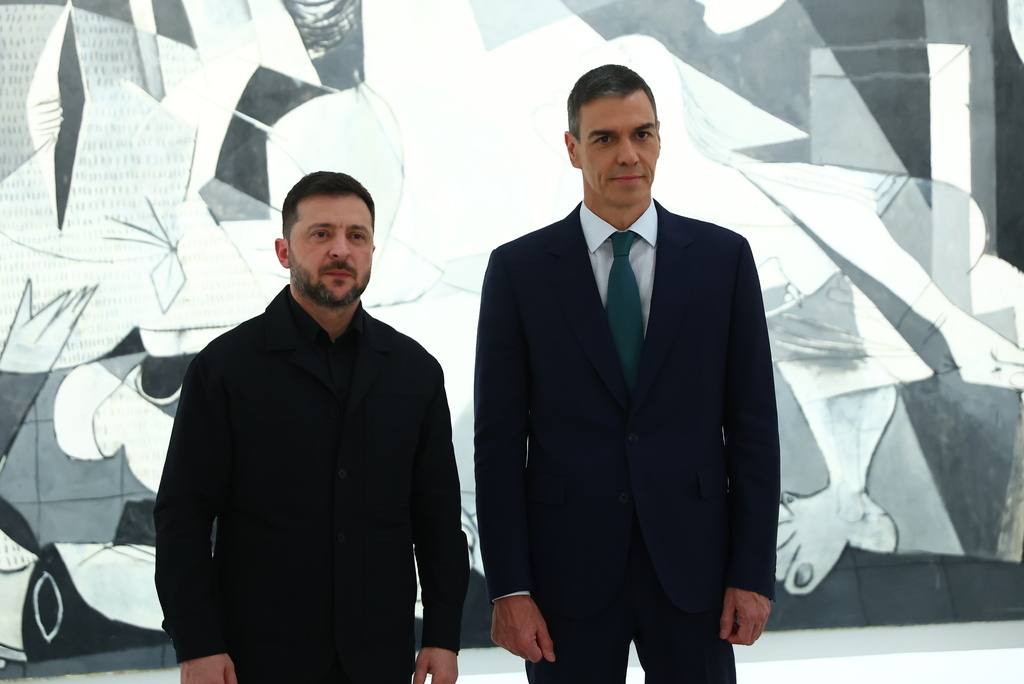 In this photo provided by the Spanish government, Ukrainian President Volodymyr Zelenskyy poses with Spain's Prime Minister Pedro Sánchez in front of Pablo Picasso's "Guernica" in Madrid Tuesday, Nov. 18, 2025. (Spanish government via AP)