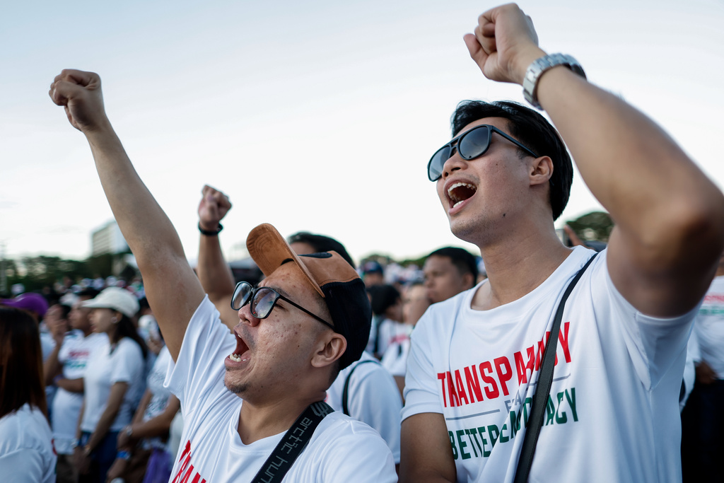 Members of the religious sect Iglesia Ni Cristo (Church of Christ) shout slogans during a three-day anti-corruption rally at Manila's Rizal Park, Philippines on Sunday, Nov. 16, 2025. (AP Photo/Mark Cristino)