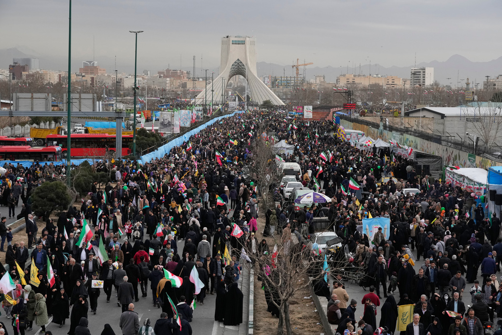 People attend an annual rally marking 1979 Islamic Revolution as the Azadi (Freedom) monument tower is seen at rear in Tehran, Iran, Wednesday, Feb. 11, 2026. (AP Photo/Vahid Salemi)