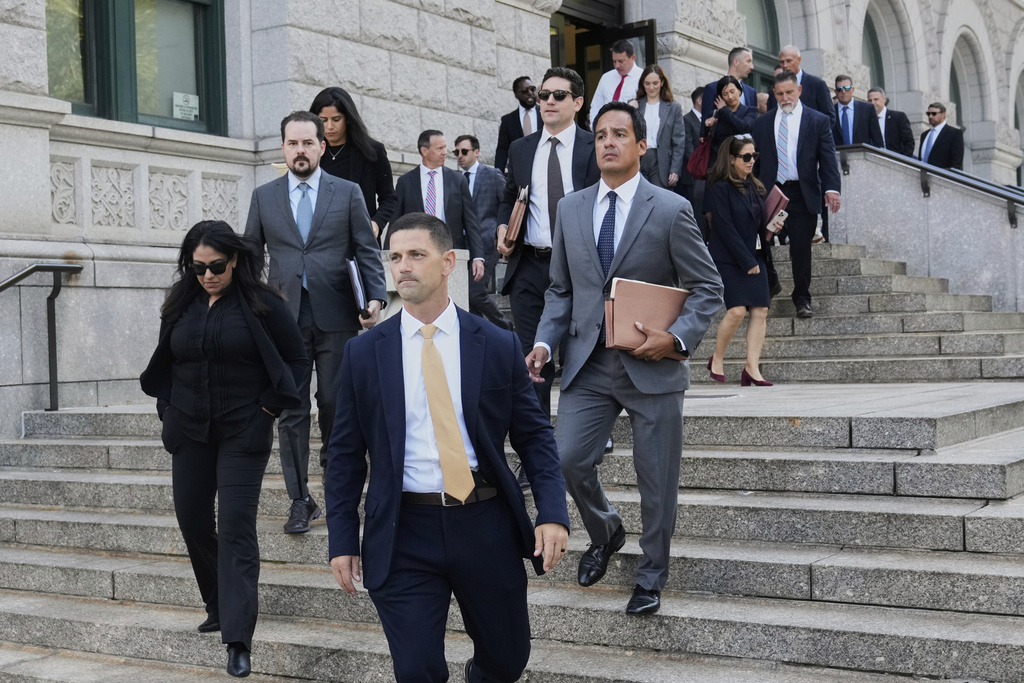 A group of people from the U.S. Attorney's office walk to Federal court in the Brooklyn borough of New York, Monday, Aug. 25, 2025. (AP Photo/Richard Drew)
