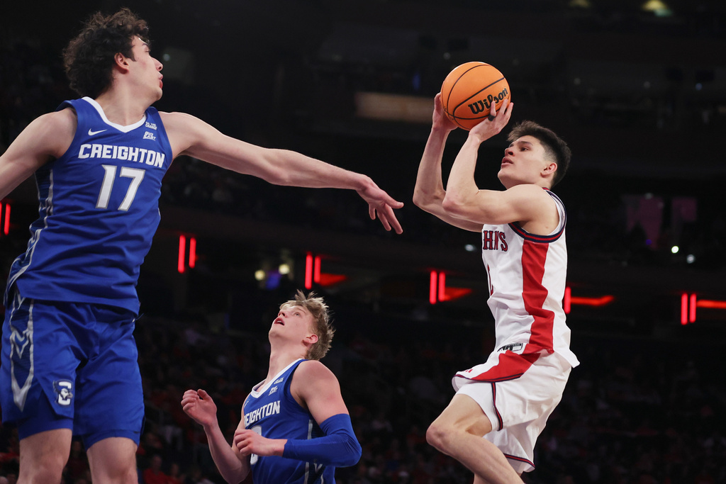 St. John's guard Dylan Darling shoots over Creighton forward Kerem Konan (17) during the second half of an NCAA college basketball game, Saturday, Feb. 21, 2026, in New York. (AP Photo/Heather Khalifa)