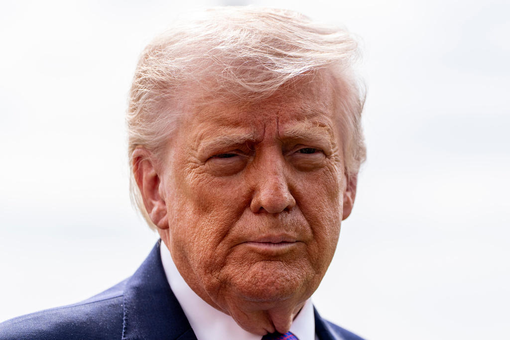 President Donald Trump speaks with reporters before departing on Marine One from the South Lawn of the White House, Wednesday, March 11, 2026, in Washington. (AP Photo/Alex Brandon)