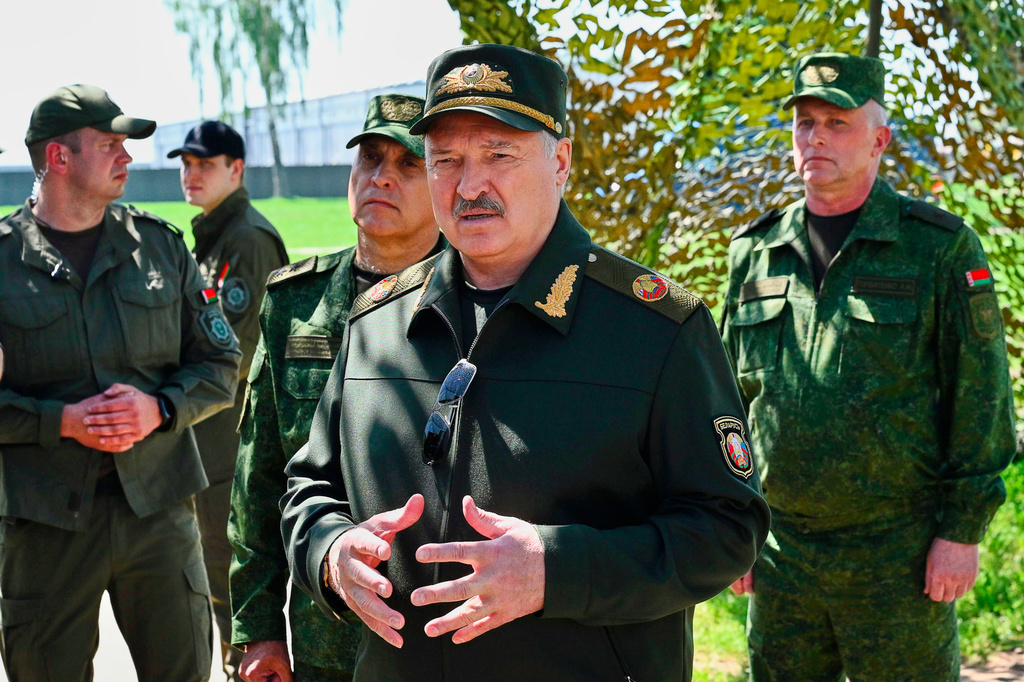 In this photo, released by Belarusian Presidential Press Service, Belarus' President Alexander Lukashenko, center, speaks to officers as he attends joint nuclear drills held by Russian and Belarusian armed forces in Asipovichy district of Belarus, Thursday, May 21, 2026. (Belarusian Presidential Press Service via AP)