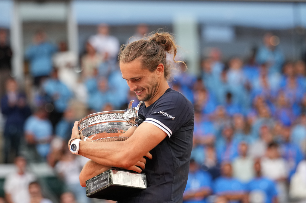 Alexander Zverev of Germany hugs the trophy after winning the men's final match against Flavio Cobolli of Italy at the French Open tennis tournament in Paris, Sunday, June 7, 2026. (AP Photo/Christophe Ena)