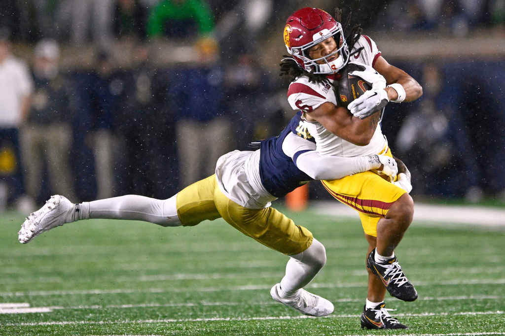 FILE - Southern California wide receiver Makai Lemon (6) catches a pass against Notre Dame's Tae Johnson (9) during the fourth quarter of an NCAA college football game, Oct. 18, 2025, in South Bend, Ind. (AP Photo/Paul Beaty, File)