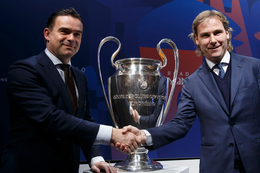 FILE - Marc Overmars, left, shakes hands with Pavel Nedved at the UEFA headquarters in Nyon, Switzerland, Friday, March 15, 2019. (Salvatore Di Nolfi/Keystone via AP, file)