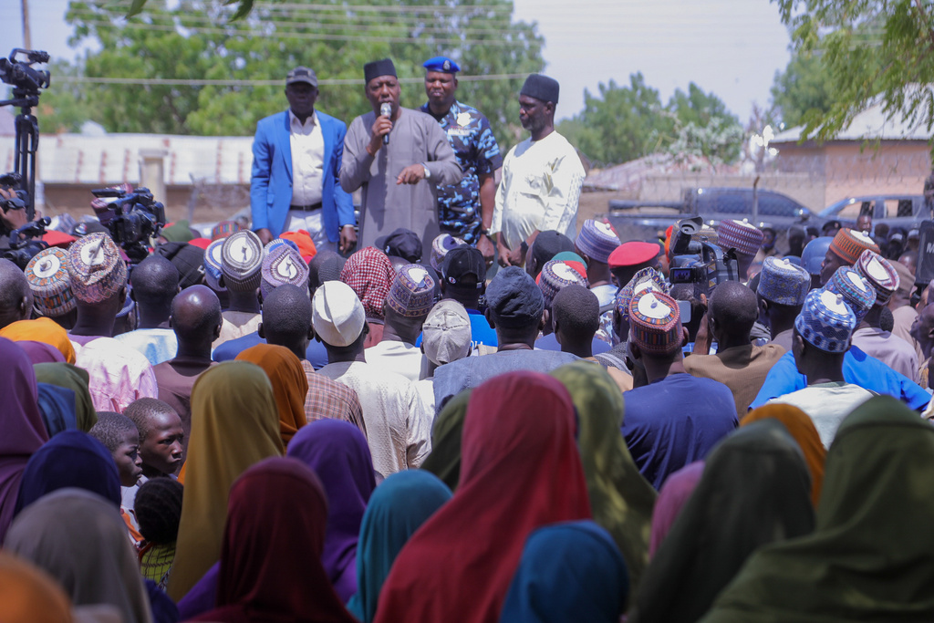 People listen to Babagana Zulum, the Borno state governor, in Pulka, Nigeria, Friday, March 6, 2026, after they fled an attack by Islamic militants in Ngoshe. (AP Photo/Jossy Ola)
