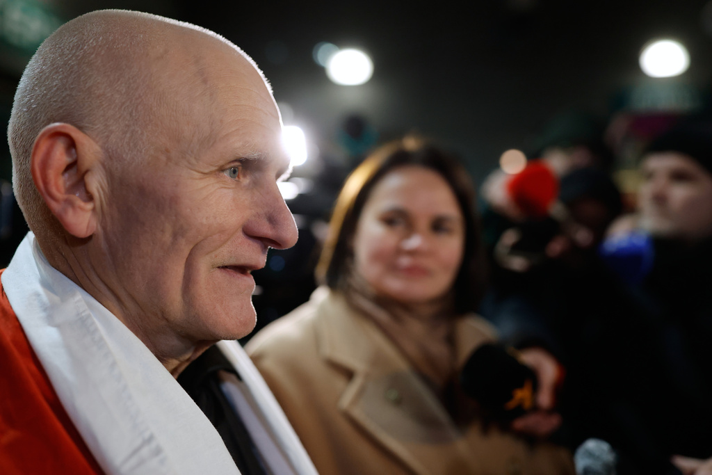 Nobel Peace Prize laureate Ales Bialiatski, one of released Belarusian prisoners, arrives at the U.S. Embassy in Vilnius, Lithuania, on Saturday, Dec. 13, 2025, as Belarusian opposition leader Sviatlana Tsikhanouskaya, background stands near. (AP Photo/Mindaugas Kulbis)