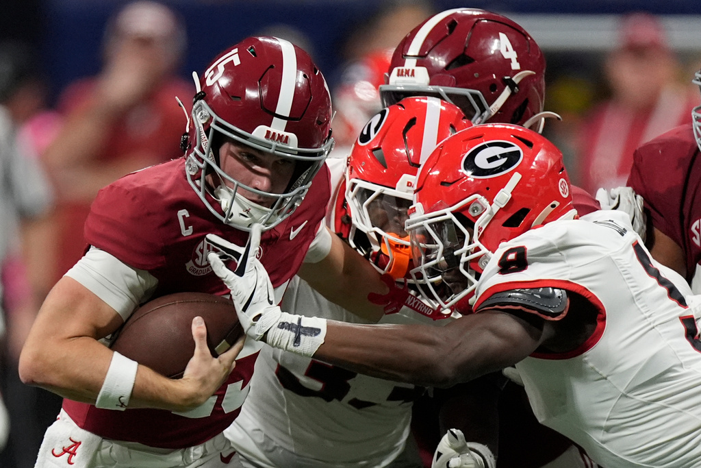 Alabama quarterback Ty Simpson (15) is tackles by Georgia linebacker Chris Cole (9) during the second half of a Southeastern Conference championship NCAA college football game, Saturday, Dec. 6, 2025, in Atlanta. (AP Photo/Mike Stewart)