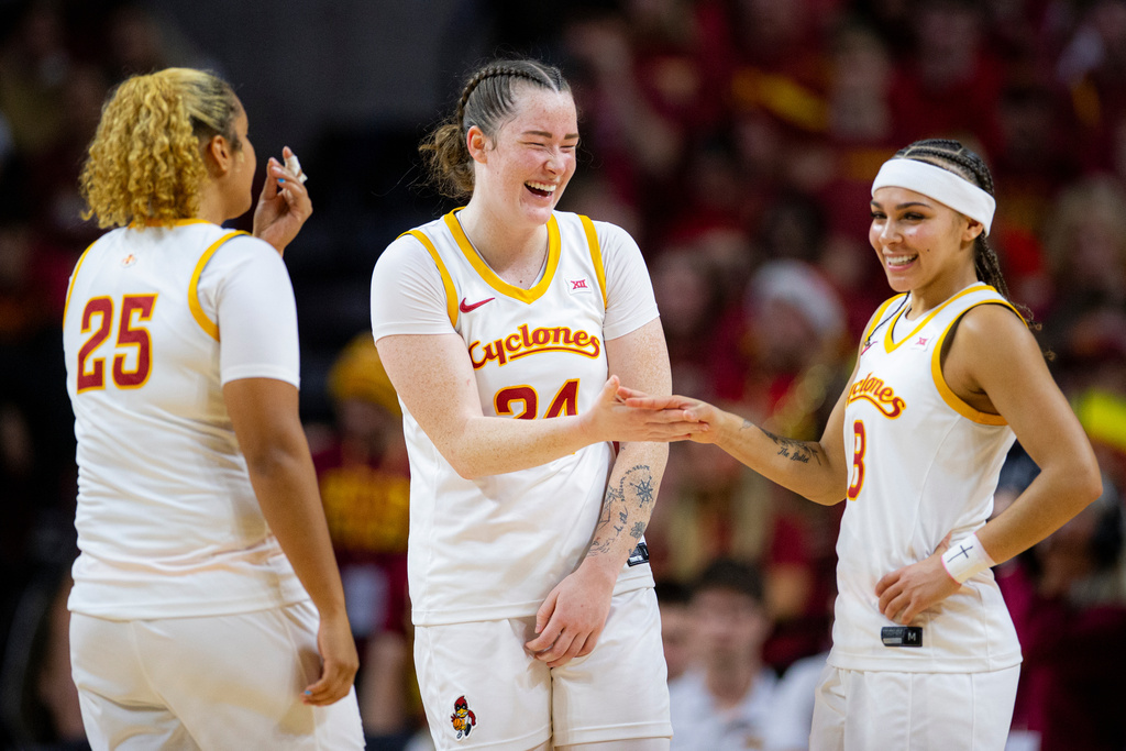 Iowa State's forward Addy Brown, center, shares a moment with forward Sydney Harris (25) and guard Jada Williams, right, during an NCAA college basketball game against Iowa in Ames, Iowa, Wednesday, Dec. 10, 2025. (Nick Rohlman/The Gazette via AP)