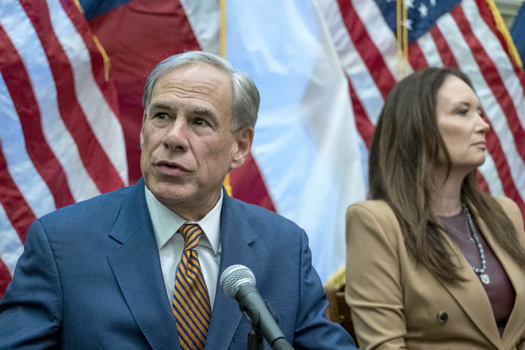 Texas Gov. Greg Abbott and U.S. Secretary of Agriculture Brooke L. Rollins discuss measures dealing with the New World screwworm during a press conference held at the state Capitol, Friday, Aug. 15, 2025, in Austin, Texas. (AP Photo/Rodolfo Gonzalez)