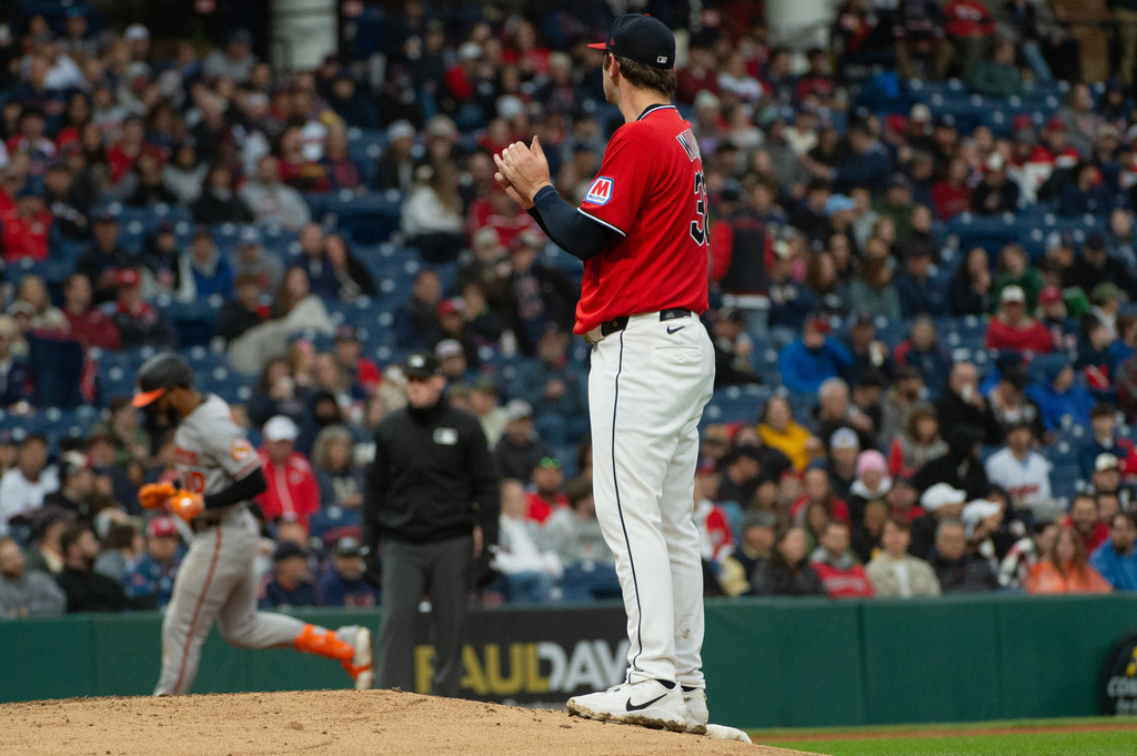 Cleveland Guardians starting pitcher Gavin Williams, foreground, watches as Baltimore Orioles' Leody Taveras, left, rounds the bases after hitting a solo home run during the fourth inning of a baseball game, Saturday, April 18, 2026, in Cleveland. (AP Photo/Phil Long)