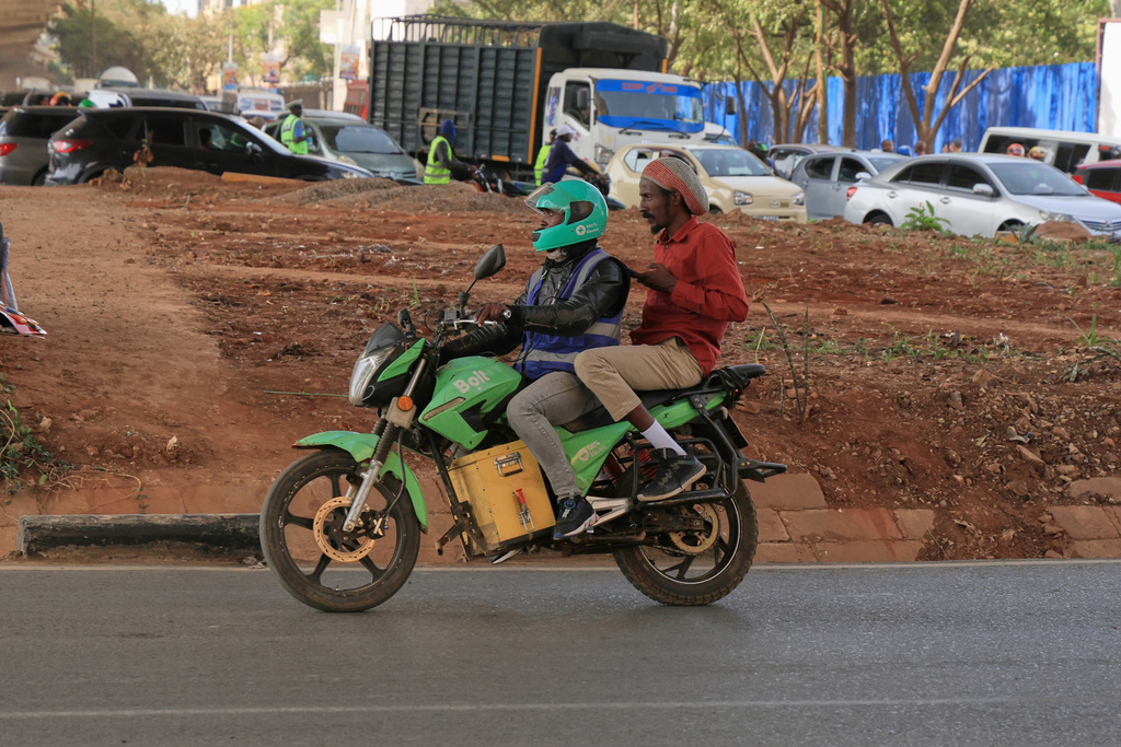 Men ride an electric motorcycle in Nairobi, Kenya, Thursday, Jan. 29, 2026. (AP Photo/Andrew Kasuku)