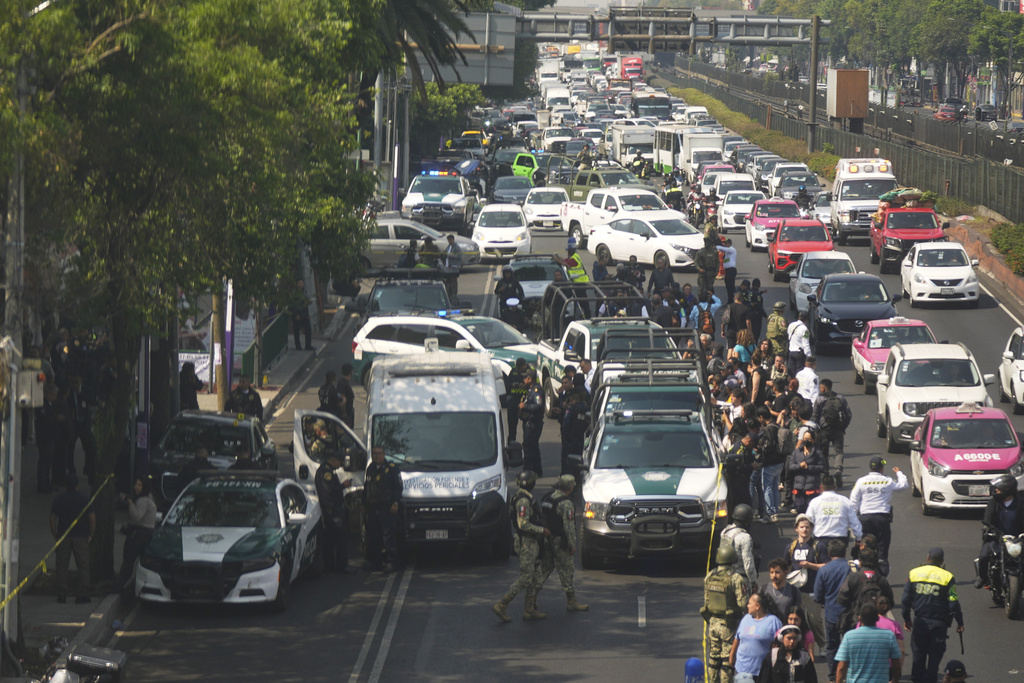 FILE - Police cordon off the area where Mexico City Mayor Clara Brugada's private secretary, Ximena Guzman, and adviser, Jose Munoz, were killed in Mexico City, May 20, 2025. (AP Photo/Fernando Llano, File)
