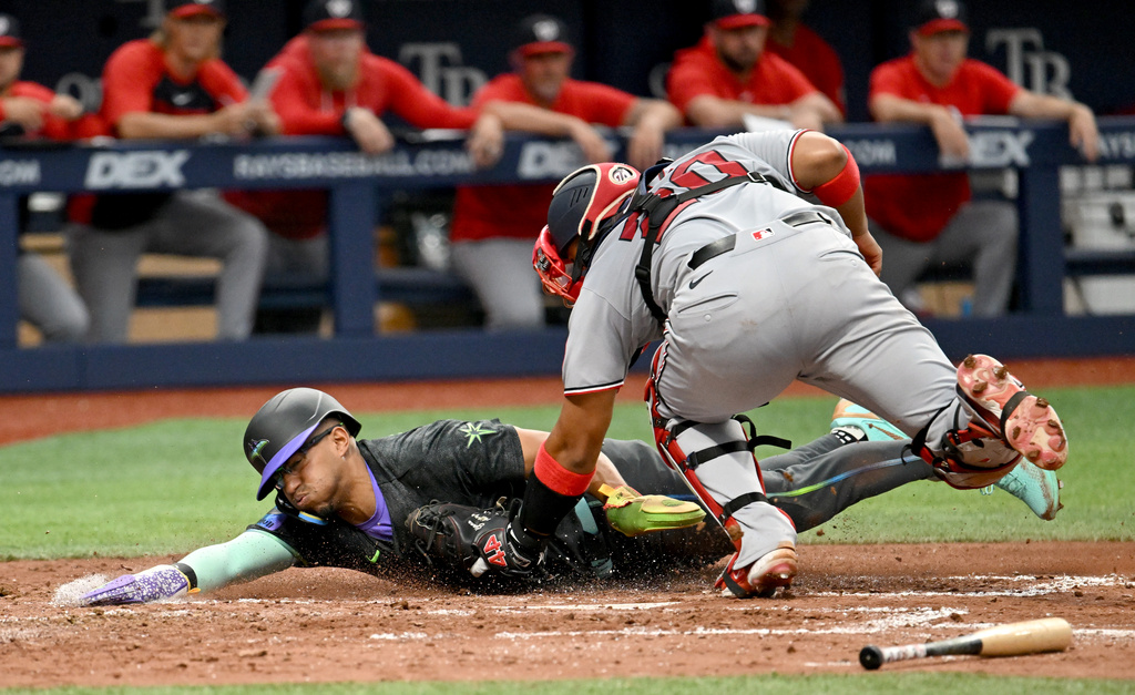 Washington Nationals catcher Keibert Ruiz (20) tags Tampa Bay Rays' Richie Palacios out at home on a fielder's choice during the third inning of a baseball game Saturday, June 20, 2026, in St. Petersburg, Fla. (AP Photo/Jason Behnken)