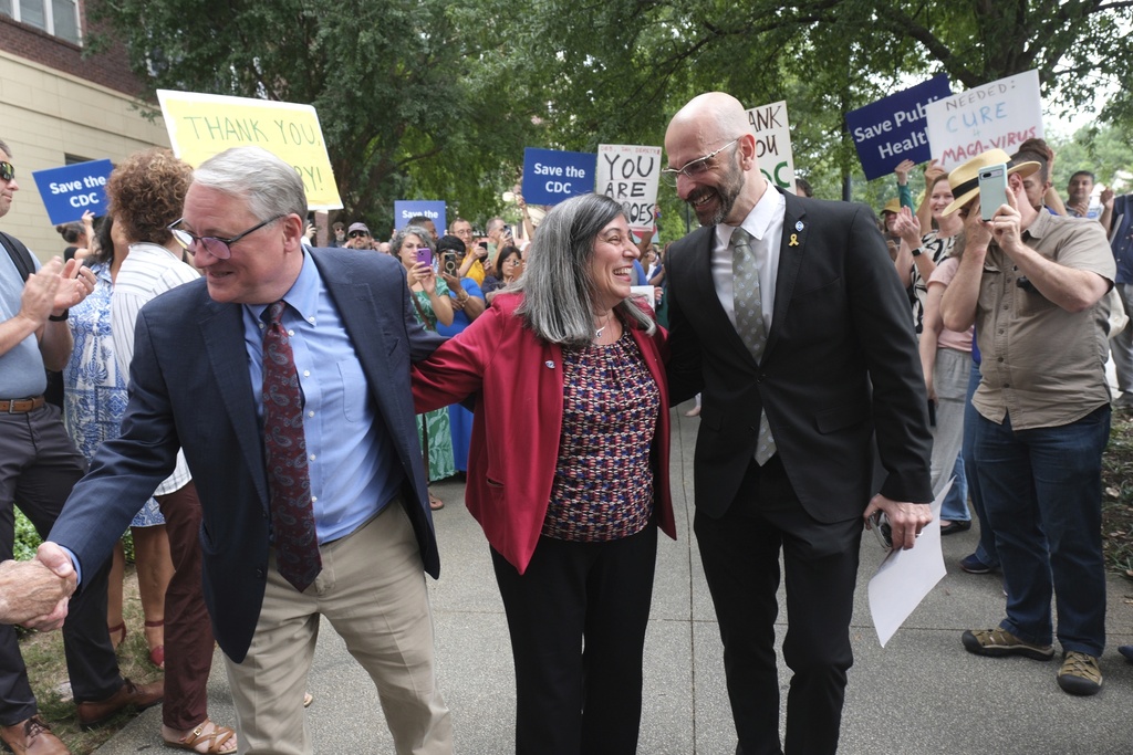 Dr. Daniel Jernigan, leader of the agency's work on emerging infectious diseases; left, Dr. Debra Houry, the agency's deputy director and Dr. Demetre Daskalakis, a top vaccine official, gather as workers and supporters rally for departing scientific leaders at the Centers for Disease Control and Prevention outside the CDC headquarters, Thursday, Aug. 28, 2025, in Atlanta. (AP Photo/Ben Gray)