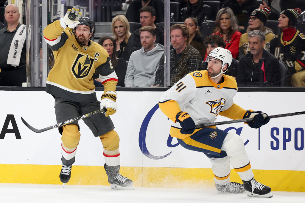 Vegas Golden Knights right wing Mark Stone (61) catches a puck against Nashville Predators defenseman Nicolas Hague (41) during the second period of an NHL hockey game Saturday, Jan. 17, 2026, in Las Vegas. (AP Photo/Ian Maule)