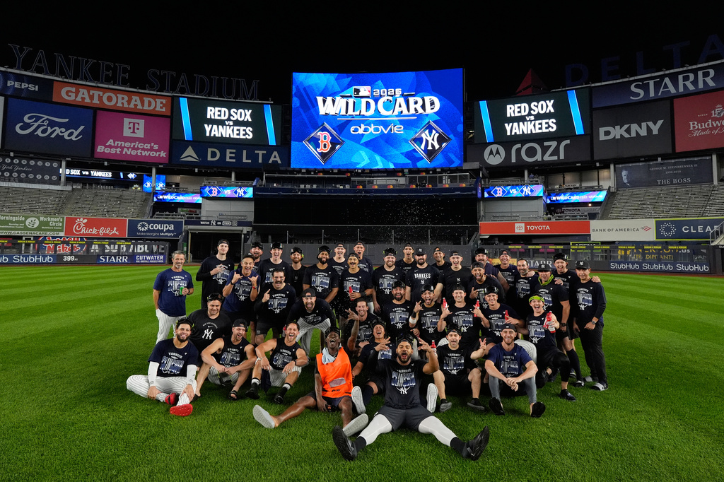 The New York Yankees take a group photo on the field to celebrate after winning baseball's American League Wild Card Series against the Boston Red Sox in Game 2, Wednesday, Sept. 30, 2026, in New York. (AP Photo/Yuki Iwamura)