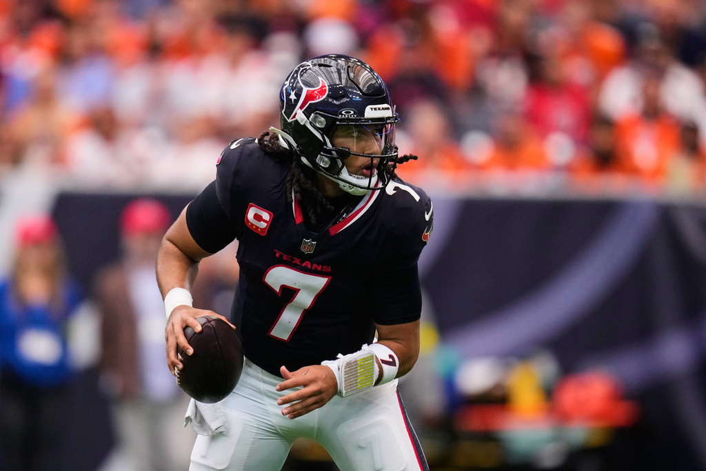Houston Texans' C.J. Stroud scrambles out of the pocket in the first half of an NFL football game against the Denver Broncos Sunday, Nov. 2, 2025, in Houston. (AP Photo/Eric Christian Smith)