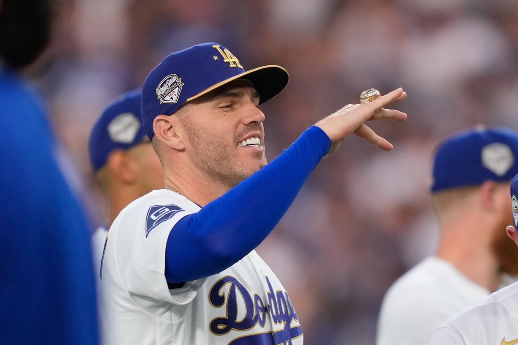 Los Angeles Dodgers' Freddie Freeman looks at his ring during a World Series ring ceremony prior to a baseball game against the Arizona Diamondbacks, Friday, March 27, 2026, in Los Angeles. (AP Photo/Mark J. Terrill)