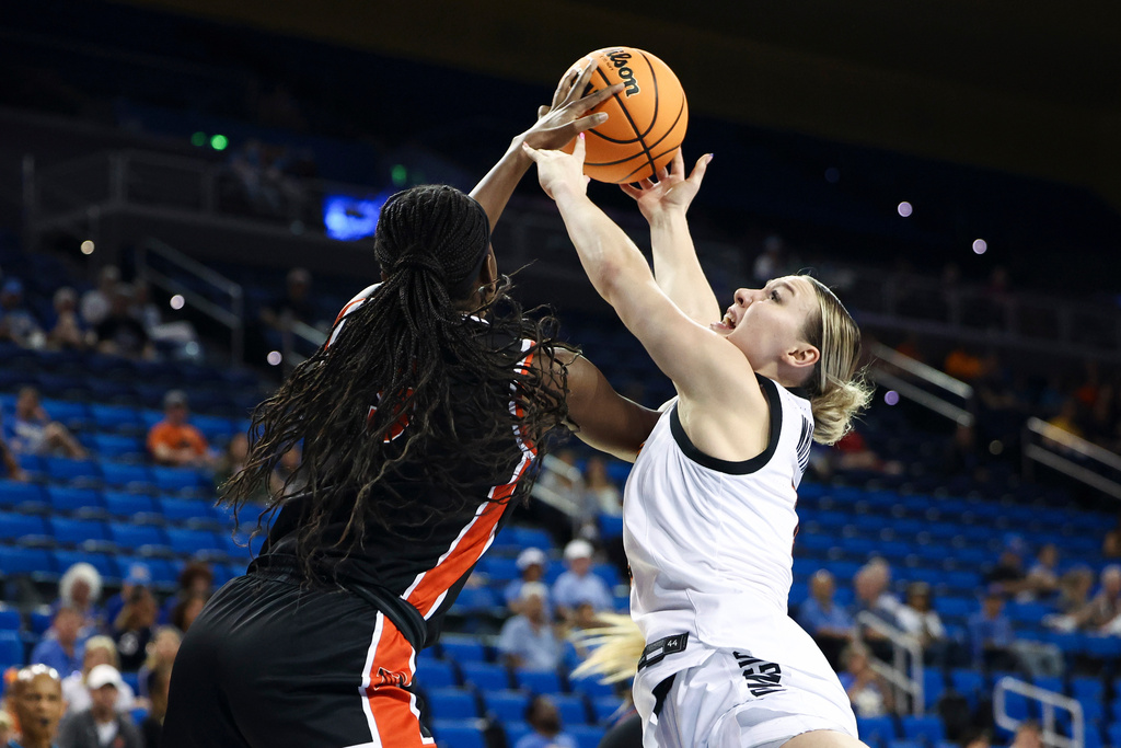 Princeton guard Fadima Tall, front, blocks a shot by Oklahoma State guard Amari Whiting, back, during the first half in the first round of the NCAA college basketball tournament, Saturday, March 21, 2026, in Los Angeles. (AP Photo/Jessie Alcheh)