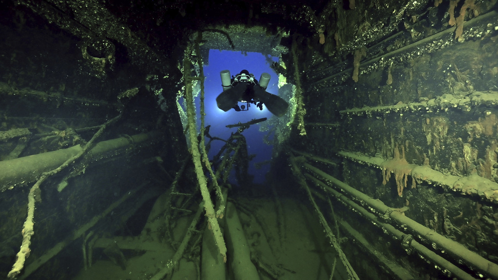 In this undated photo provided by the Greek Culture Ministry on Monday, Sept. 15, 2025, divers illuminate the wreck's interior of the Britannic, sister ship to the Titanic, for the first time since the ocean liner sank in the Aegean Sea more than a century ago after striking a mine during World War I. (Greek Culture Ministry via AP)