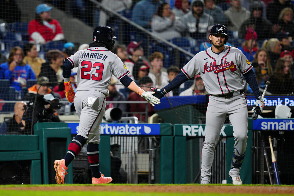 Atlanta Braves' Michael Harris II (23) celebrates with Austin Riley, right, after scoring during the fifth inning of a baseball game against the Philadelphia Phillies, Sunday, April 19, 2026, in Philadelphia. (AP Photo/Derik Hamilton)