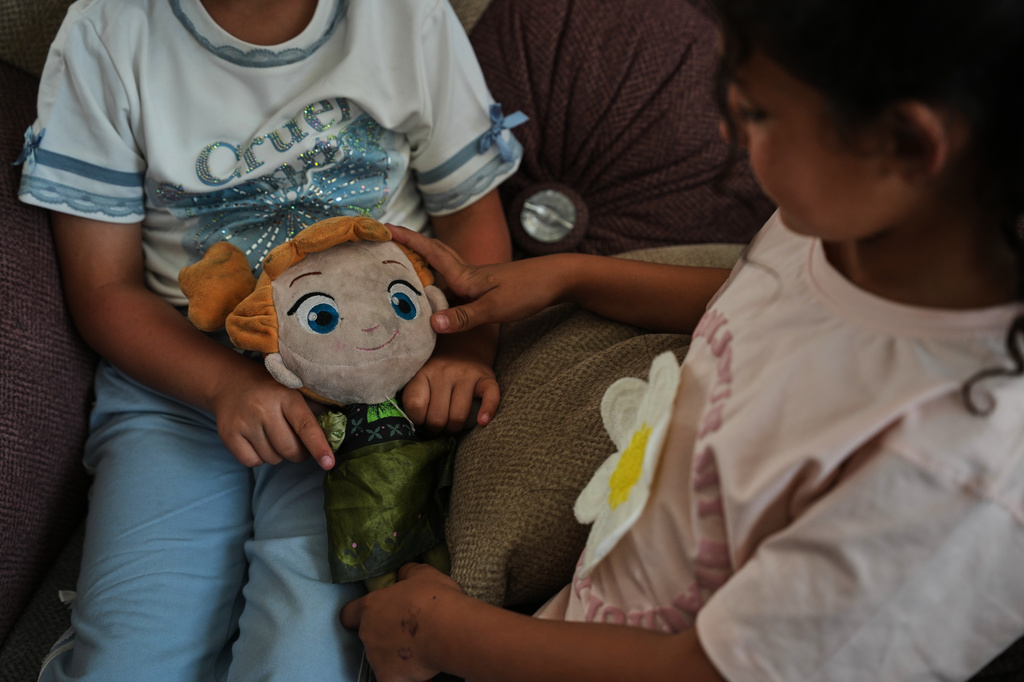 Palestinian orphan sisters Nabila and Basmala Al-Kafarna play with a doll at their home in Gaza City, May 31, 2026. Their parents were killed in an Israeli airstrike that struck a school sheltering displaced people on April 3, 2025. (AP Photo/Abdel Kareem Hana)