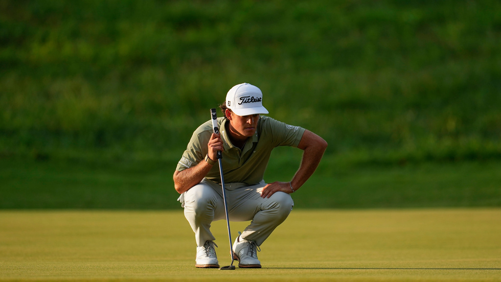 Jackson Koivun lines up his ball on the first green during the first round of the St. Jude Championship golf tournament, Thursday, Aug. 13, 2026, in Memphis, Tenn. (AP Photo/George Walker IV)
