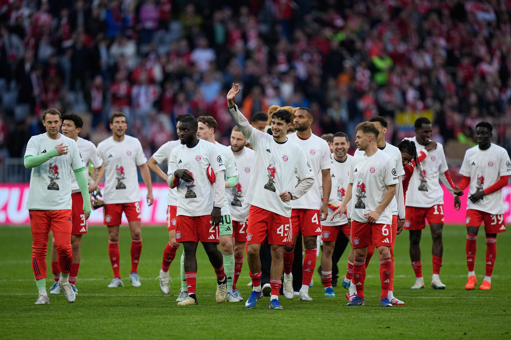 Bayern players celebrate after their team clinched the German league title after a Bundesliga soccer match between Bayern and Stuttgart in Munich, Germany, Sunday, April 19, 2026. (AP Photo/Matthias Schrader)