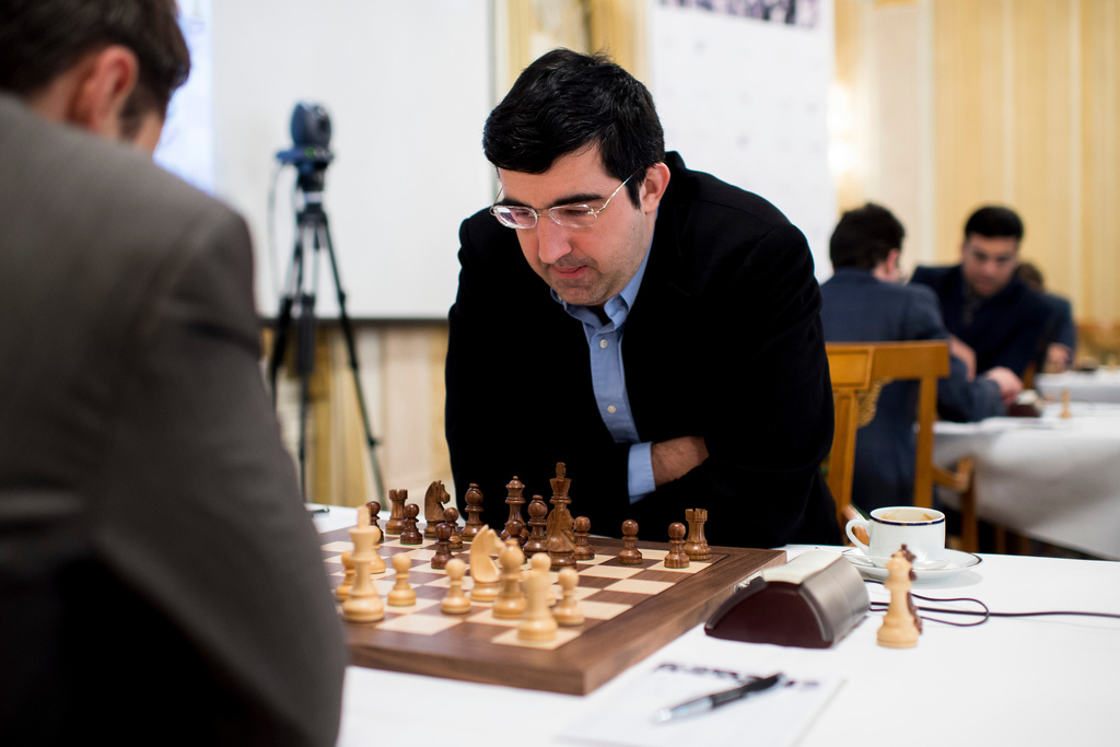 FILE - Russian chess grandmaster Vladimir Kramnik, right, concentrates during his game against U.S. grandmaster Lewon Aronjan during the Zurich Chess Challenge 2015 Round 3 in Zurich, Feb. 16, 2015. (Ennio Leanza/Keystone via AP)