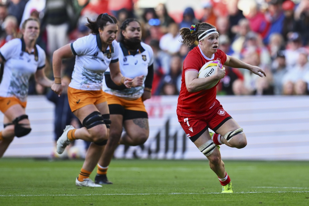 Canada's Karen Paquin, right, breaks away to score a try during the Women's Rugby World Cup 2025 quarterfinal match between Canada and Australia, in Bristol, England, Saturday, Sept. 13, 2025. (AP Photo/Anthony Upton)