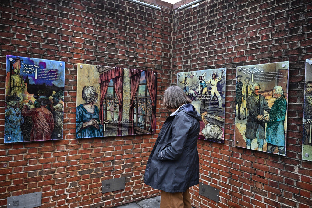 A person views panels that were part of an exhibit on slavery at the President's House Site in Philadelphia after they are put back Thursday, Feb. 19, 2026. (AP Photo/Joe Lamberti)