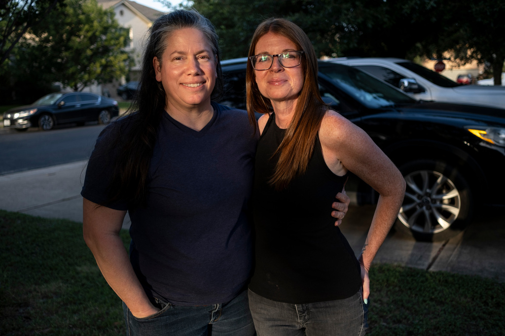 Jamie Corum and her wife Jessica Edgar-Corum pose for a portrait outside their home on Monday, June 29, 2026, in Pflugerville, Texas. (AP Photo/Joel Angel Juarez)