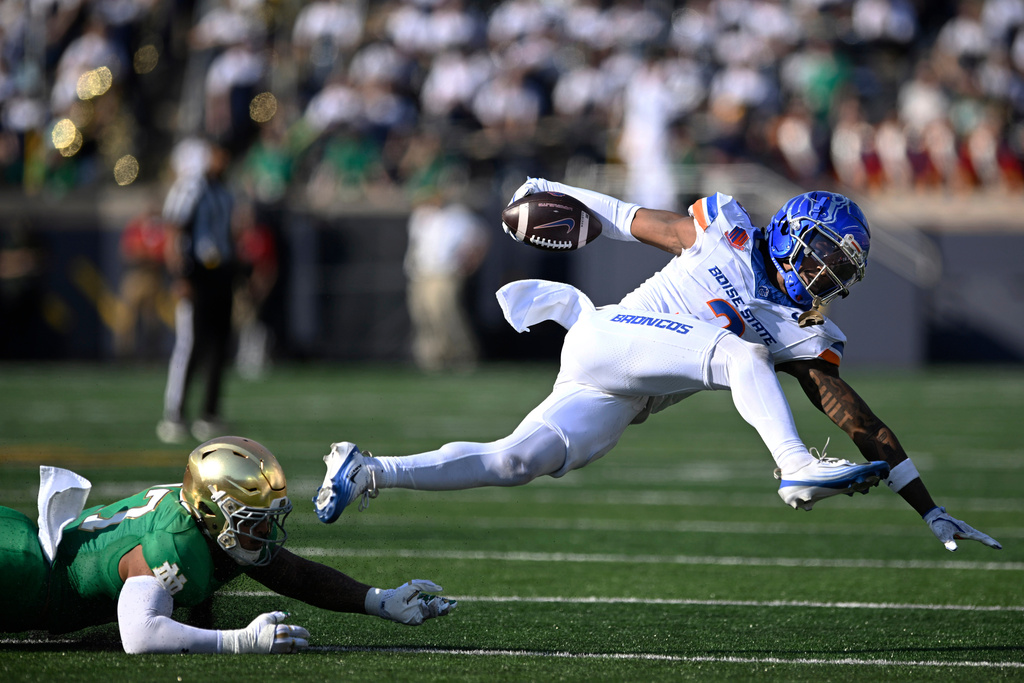 Boise State wide receiver Latrell Caples (3) rushes against Notre Dame's Jalen Stroman (7) after catching a pass during the first quarter of an NCAA football game Saturday, Oct. 4, 2025, in South Bend, Ind. (AP Photo/Paul Beaty)