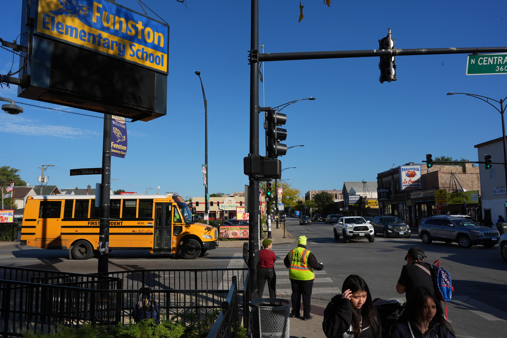 People walk outside Funston Elementary School in Chicago's Logan Square neighborhood, Thursday, Oct. 16, 2025. (AP Photo/Rebecca Blackwell)