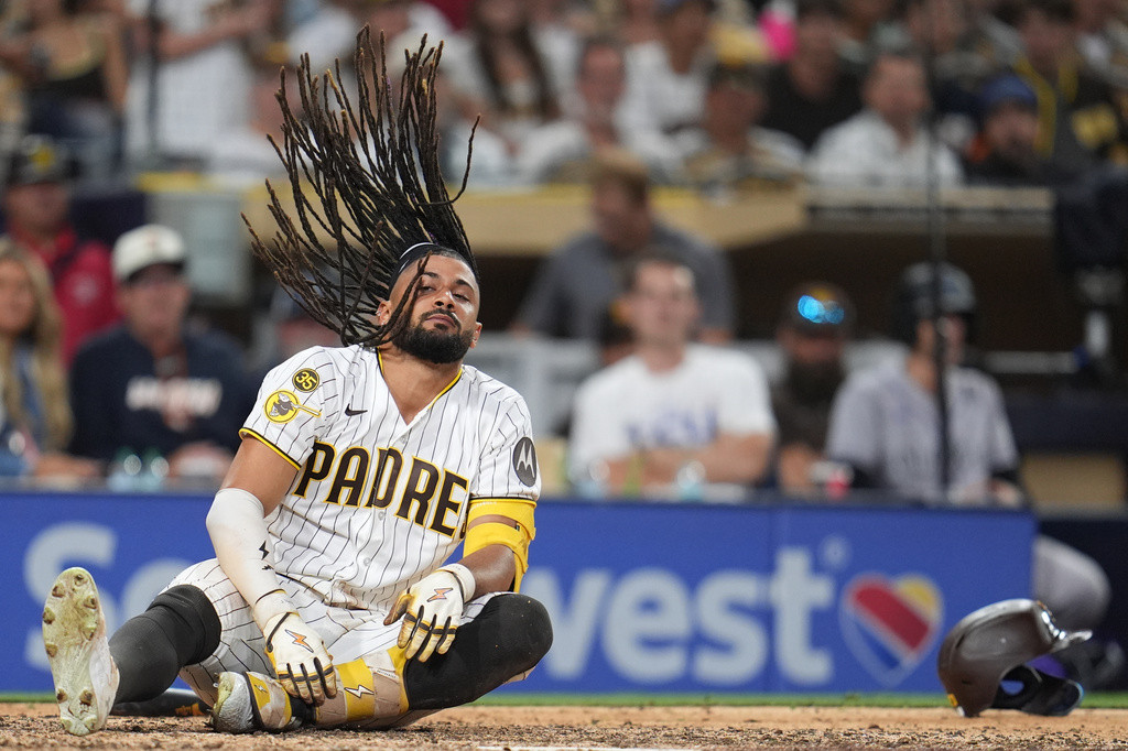 San Diego Padres' Fernando Tatis Jr. falls after moving away from an inside pitch while batting during the eighth inning of a baseball game against the Colorado Rockies Tuesday, July 28, 2026, in San Diego. (AP Photo/Gregory Bull)