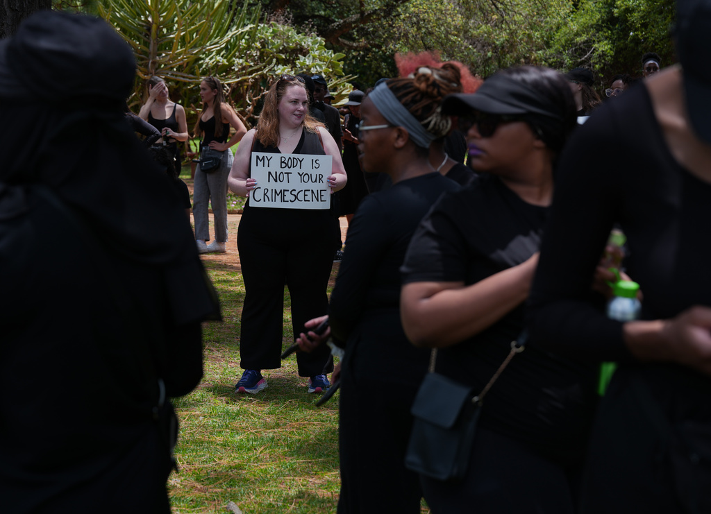 A participant holds a sign reading "My body is not your crime scene" during a gender-based violence protest at the forecourt of the botanical gardens in Johannesburg, South Africa, Friday, Nov. 21, 2025. (Misper Apawu)