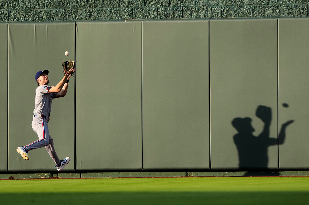 Texas Rangers center fielder Evan Carter catches a line drive for the out on Kansas City Royals' Maikel Garcia during the third inning of a baseball game Wednesday, June 10, 2026, in Kansas City, Mo. (AP Photo/Charlie Riedel)