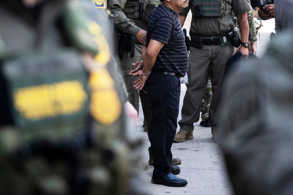 Federal immigration enforcement agents detain a man who took off running away from them as they were walking on North Clark Street near West Superior Street in the River North neighborhood, Sunday, Sept. 28, 2025, in Chicago. (Ashlee Rezin/Chicago Sun-Times via AP)
