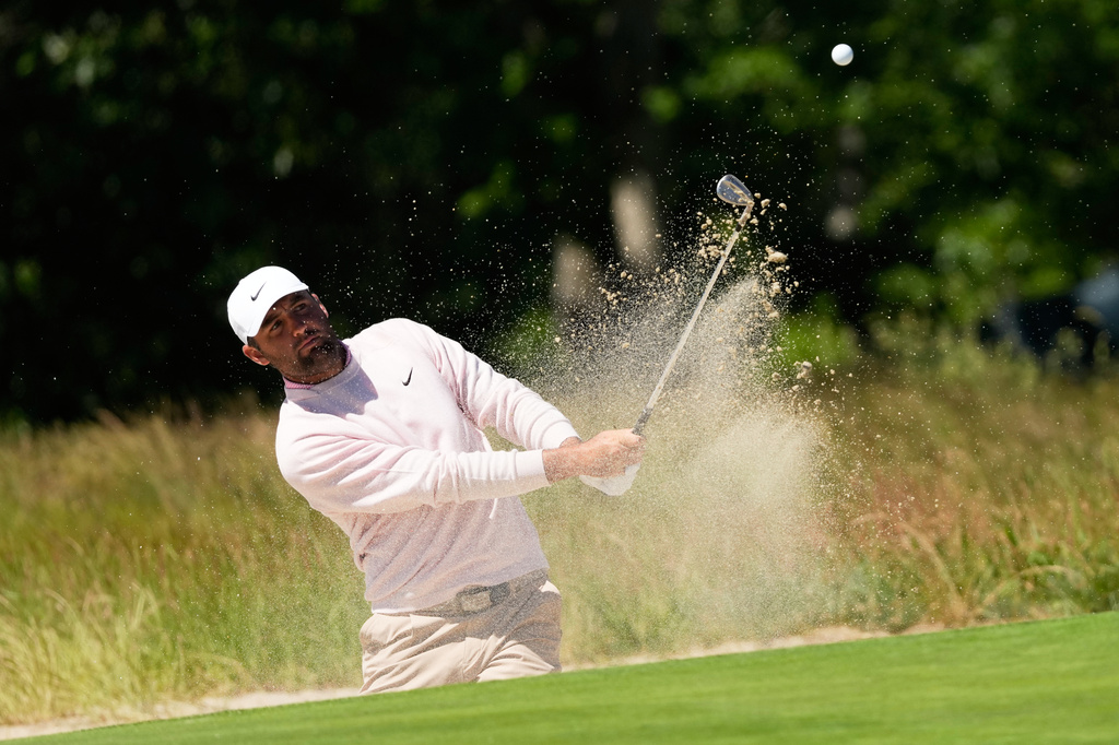 Scottie Scheffler hits from the bunker on the second hole during a practice round for the U.S. Open golf tournament at Shinnecock Hills Golf Club in Southampton, N.Y., Tuesday, June 16, 2026.(AP Photo/David J. Phillip)