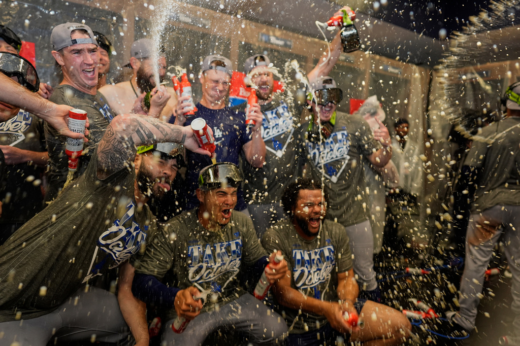 Los Angeles Dodgers players celebrate winning Game 4 of baseball's National League Division Series against the Atlanta Braves, Wednesday, Oct. 7, 2026, in Atlanta. (AP Photo/Mike Stewart)