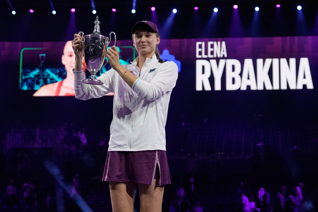 Elena Rybakina of Kazakhstan poses with the trophy after defeating Aryna Sabalenka of Belarus in the women's final singles match of the WTA finals in Riyadh, Saudi Arabia, Saturday, Nov. 8, 2025. (AP Photo/ Fatima Shbair)