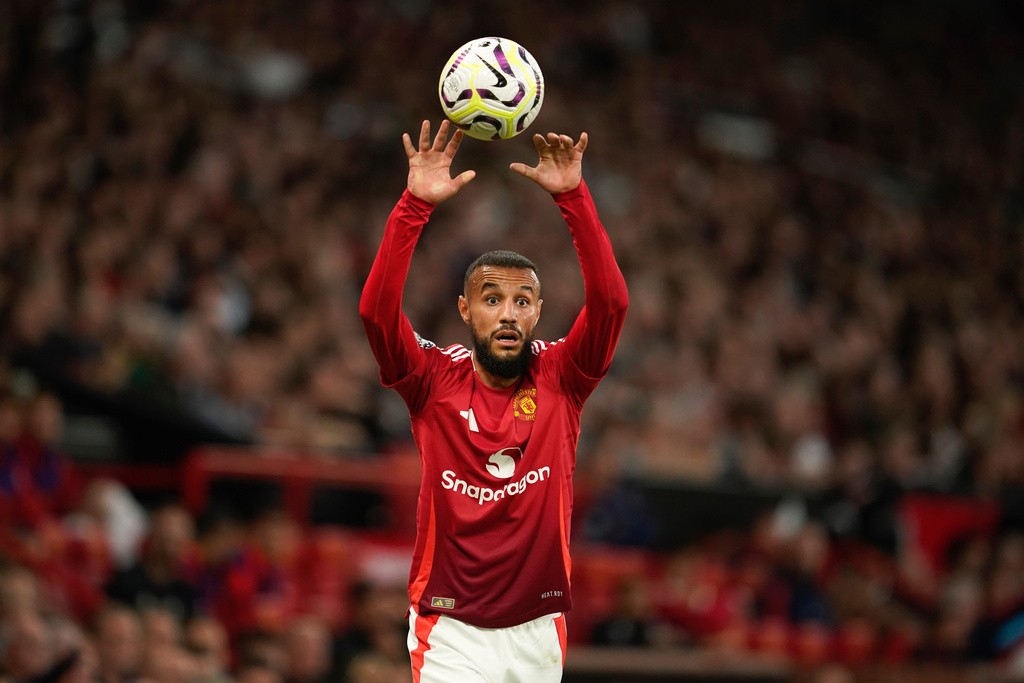 FILE - Manchester United's Noussair Mazraoui takes a throw-in during the English Premier League soccer match between Manchester United and Fulham at Old Trafford, on Aug. 16, 2024, in Manchester, England. (AP Photo/Dave Thompson, File)