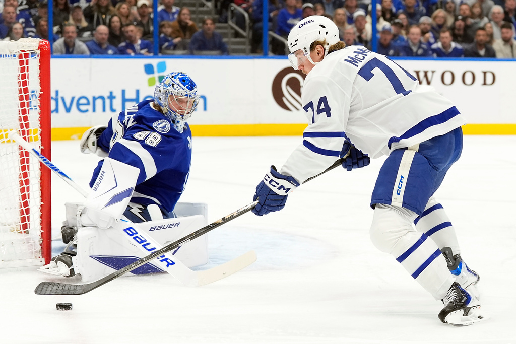 Toronto Maple Leafs center Bobby McMann (74) tries to shoot on Tampa Bay Lightning goaltender Andrei Vasilevskiy (88) during the first period of an NHL hockey game Wednesday, Feb. 25, 2026, in Tampa, Fla. (AP Photo/Chris O'Meara)