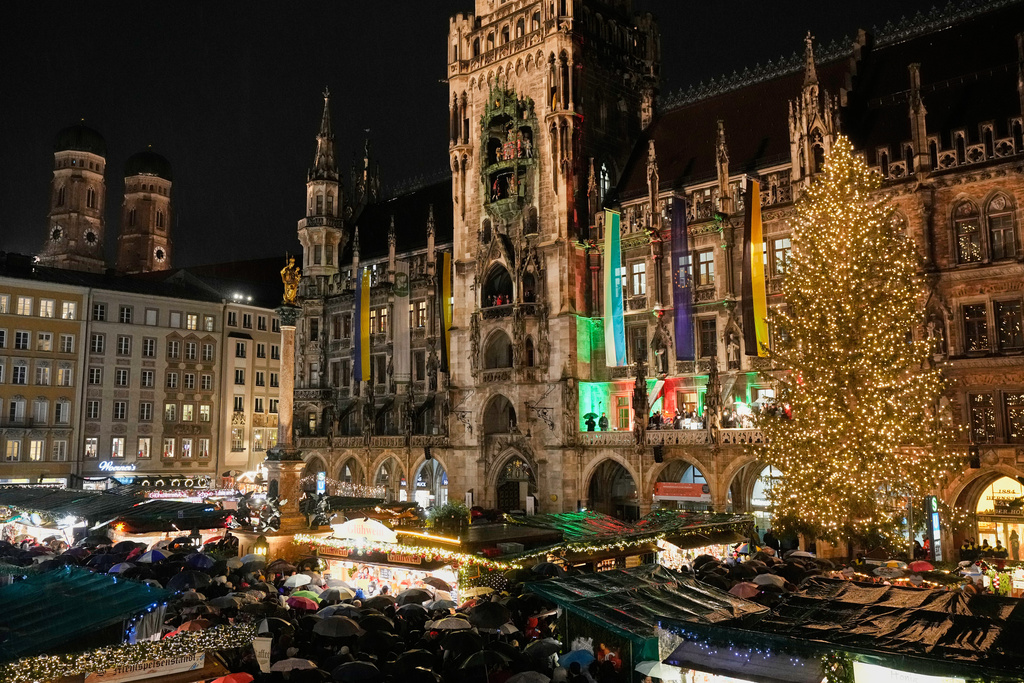 Lights illuminate the traditional Christmas Market that was opened at 'Marienplatz' square in Munich, Germany, Monday, Nov. 24, 2025. (AP Photo/Matthias Schrader)